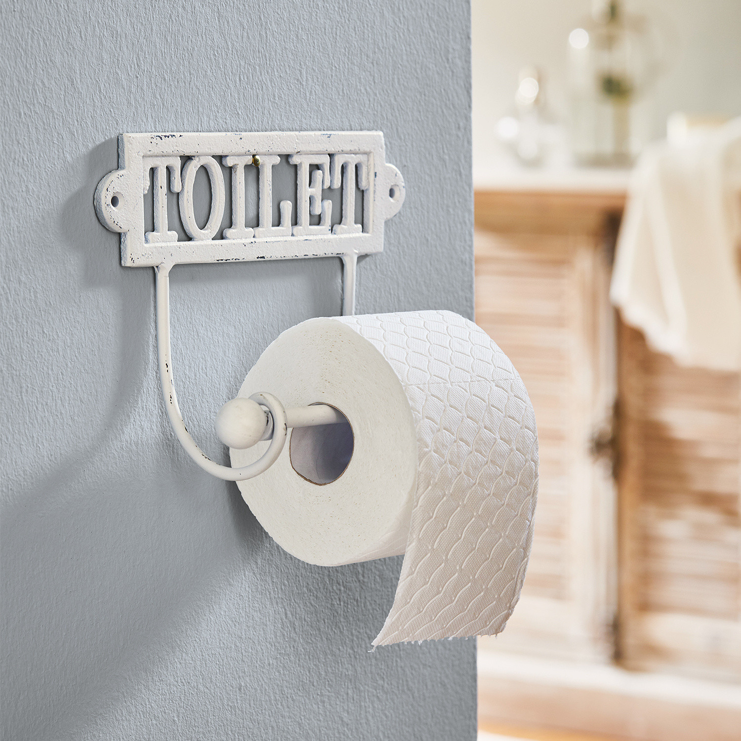 Witte metalen toiletrolhouder met tekst TOILET in vintage stijl voor badkamer