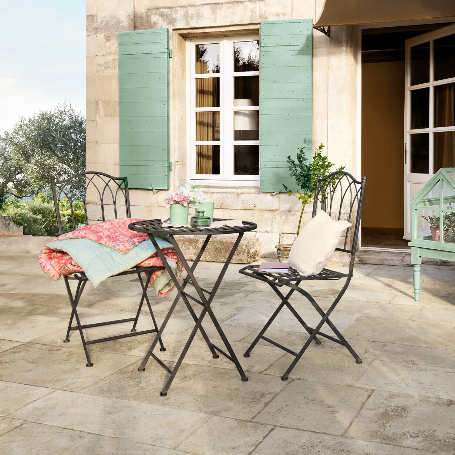 Tuinset Brignoles Zwart metalen tuinmeubelset met twee stoelen en een ronde tafel op het terras