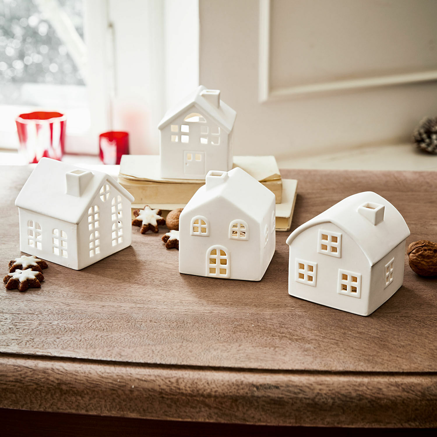 Windlicht set van 4 Country Witte keramische huisjes met openingen voor kaarslicht op houten tafel, feestelijke decoratie