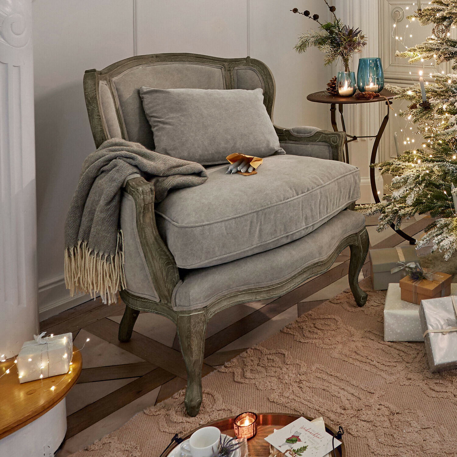 Fauteuil Kingswinford Grijze gestoffeerde bank met houten frame in gezellige kamer met kerstboom en cadeaus