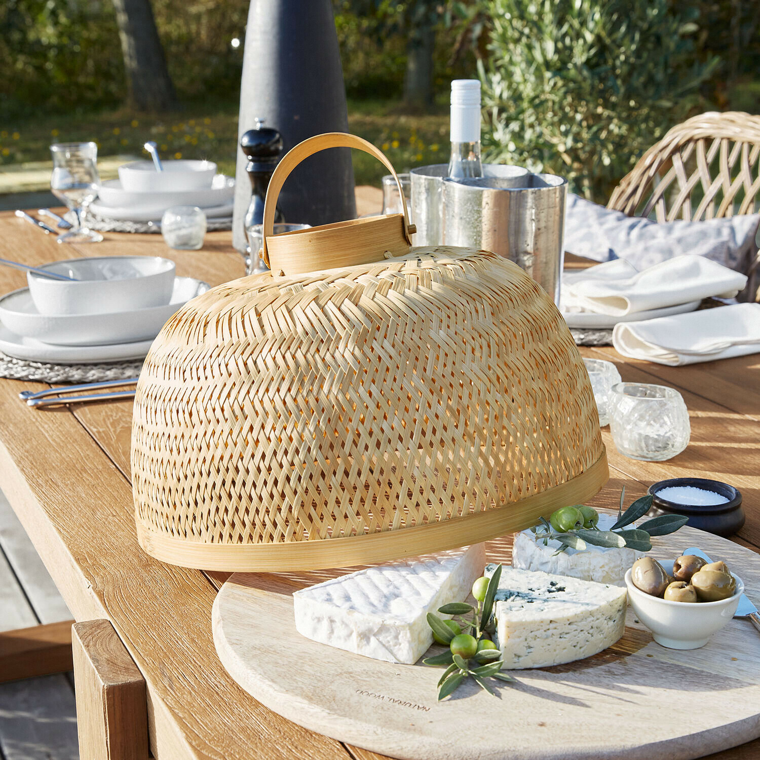 Natuurlijke bamboe kaasstolp met handvat op houten plank voor buiten serveren van kaas