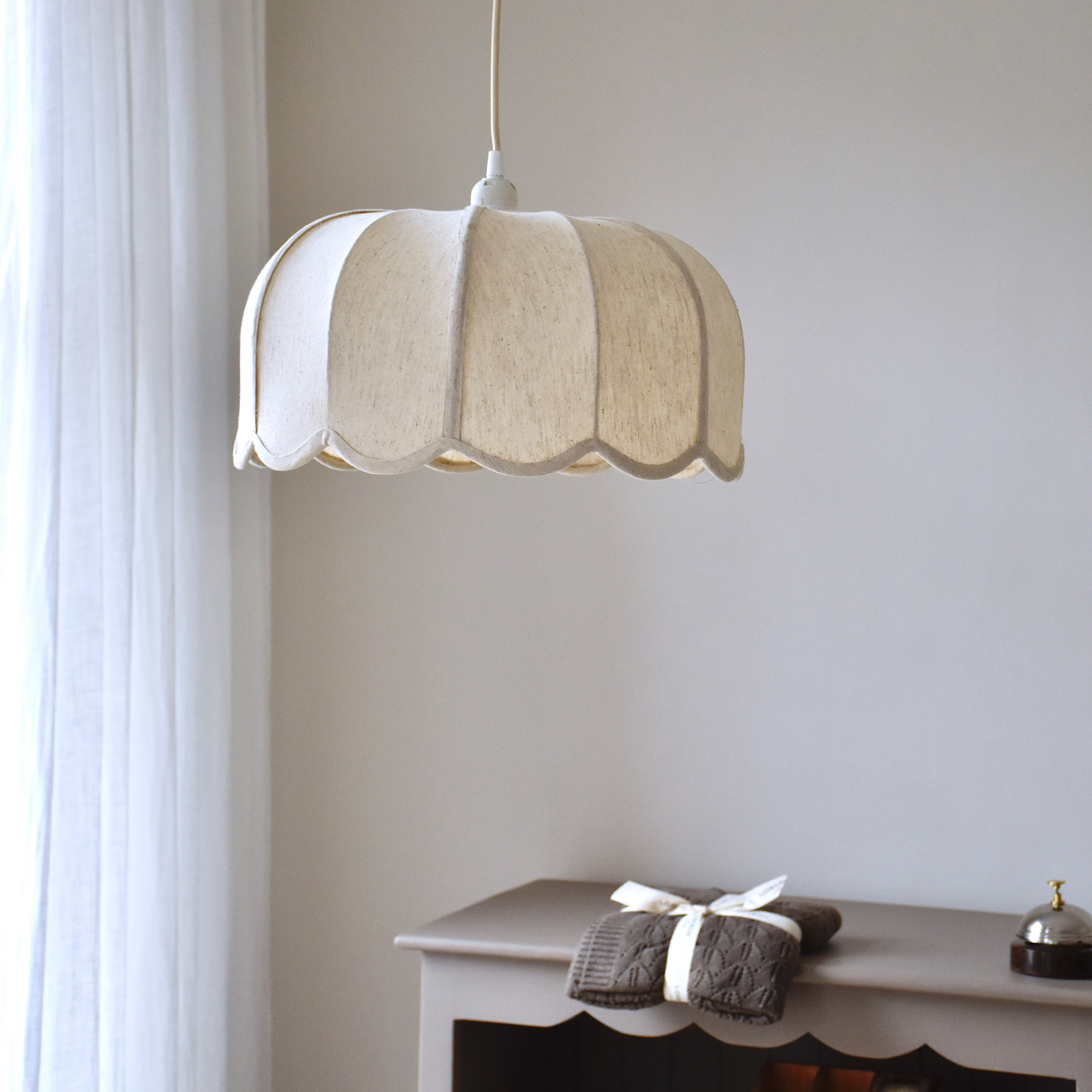 Hanglamp van crèmekleurige stof met golvend ontwerp, zachte verlichting voor binnenruimtes