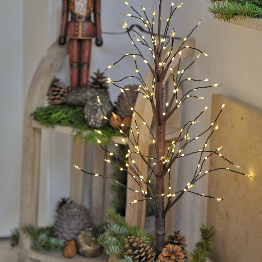 Decoratieve lichtboom van bruin materiaal met warmwitte LED-lampjes en dennenappels