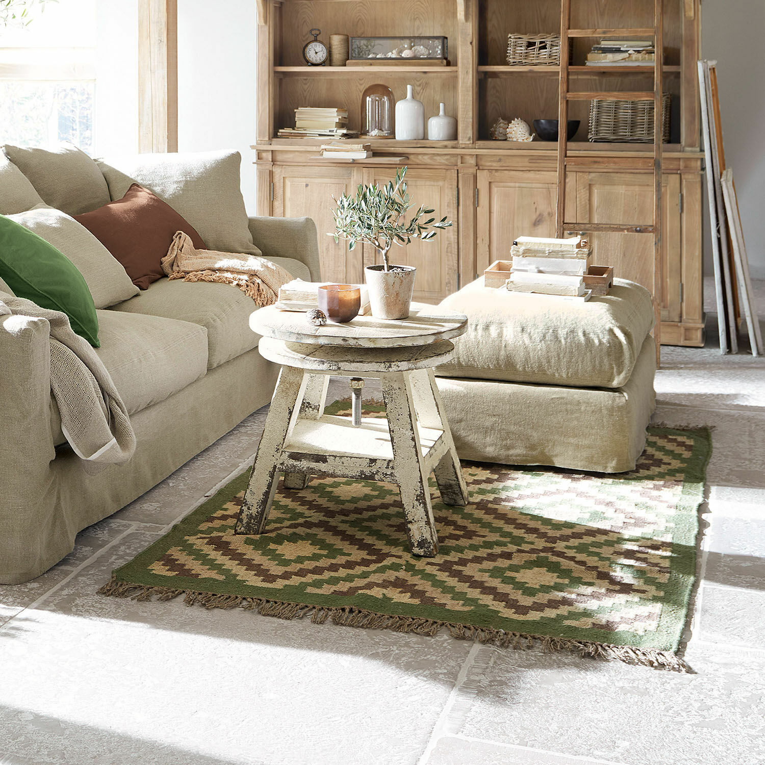 Vloerkleed Dailies Gezellige woonkamer met beige bank, houten vintage tafel en groenbruine vloerkleed