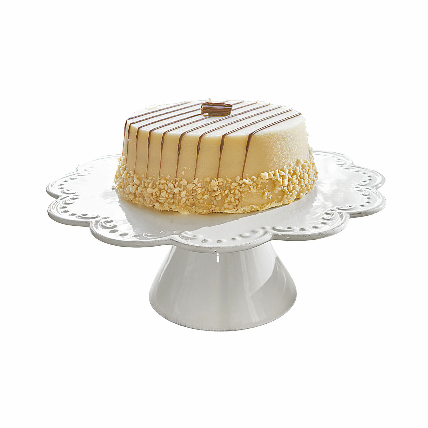 Taart op witte keramische standaard met romige glazuur en notenstukjes, feestelijk dessert