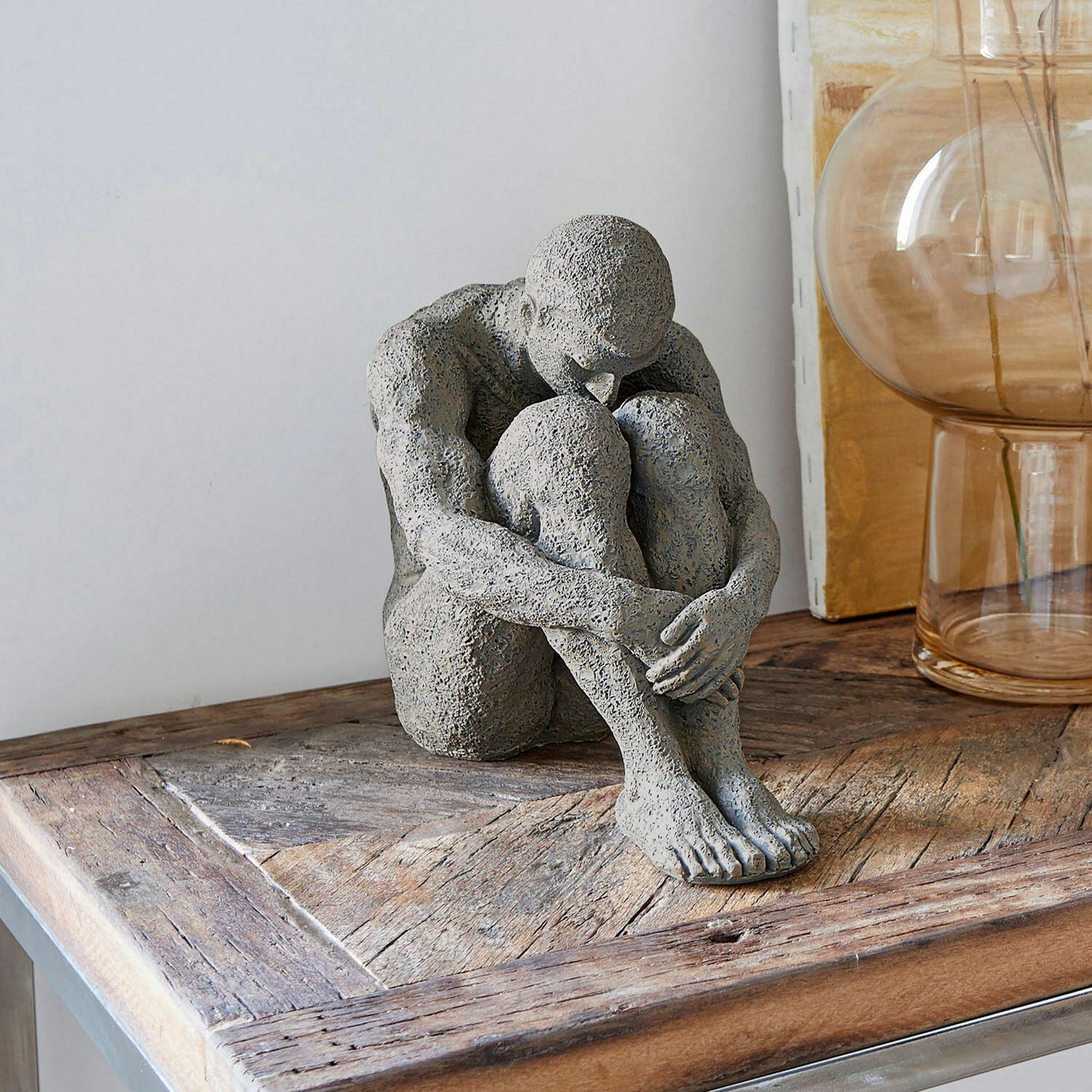 Beeld Antony Grijs stenen beeld van zittend figuur op houten tafel, moderne interieurdecoratie