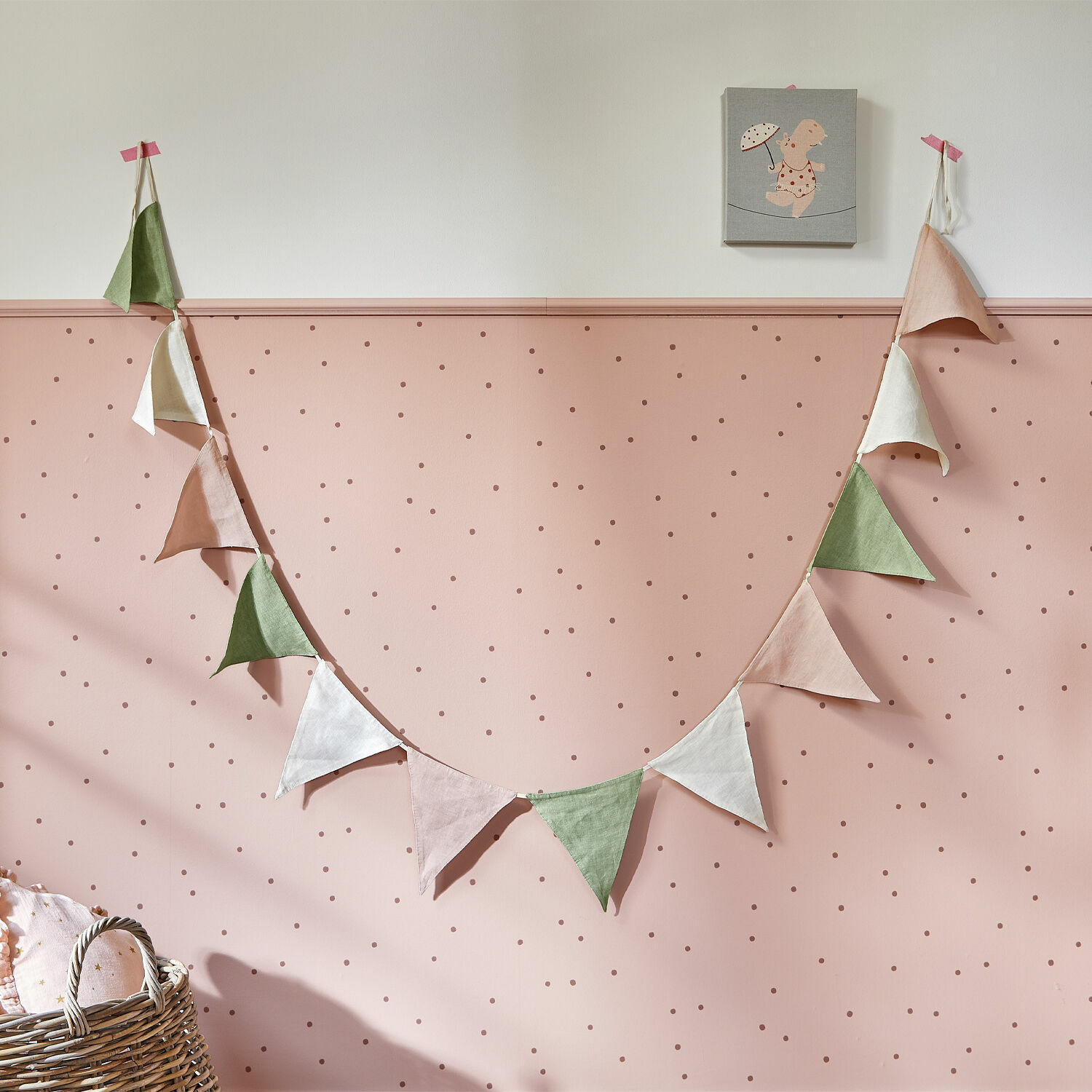 Vlaggenlijn Rêveline Slingervlaggen van linnen in pasteltinten aan roze muur met stippen voor kinderkamer