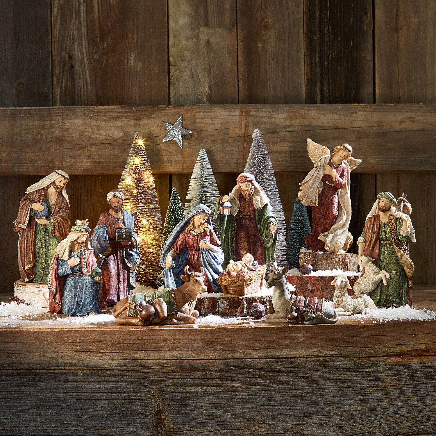 Set kerststalfiguren van hout en hars in natuurlijke kleuren op houten achtergrond