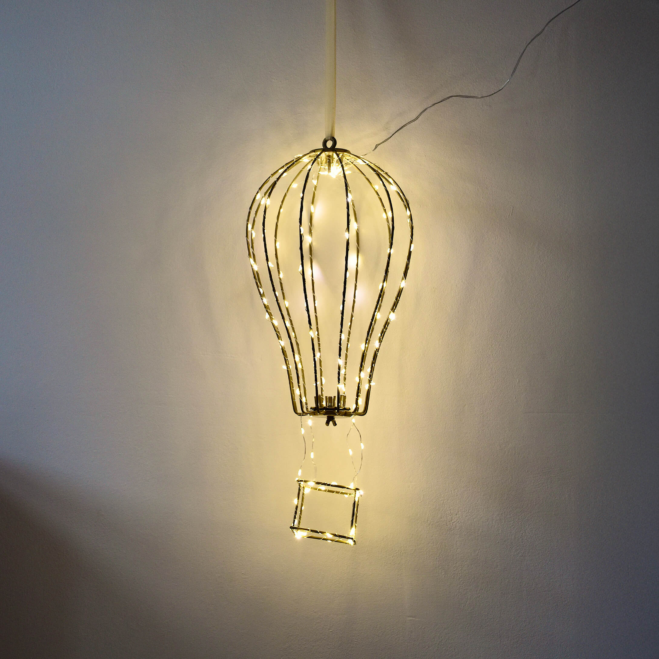 Decoratieve lamp in de vorm van een luchtballon van metalen frame met warme LED-lichtjes aan de muur