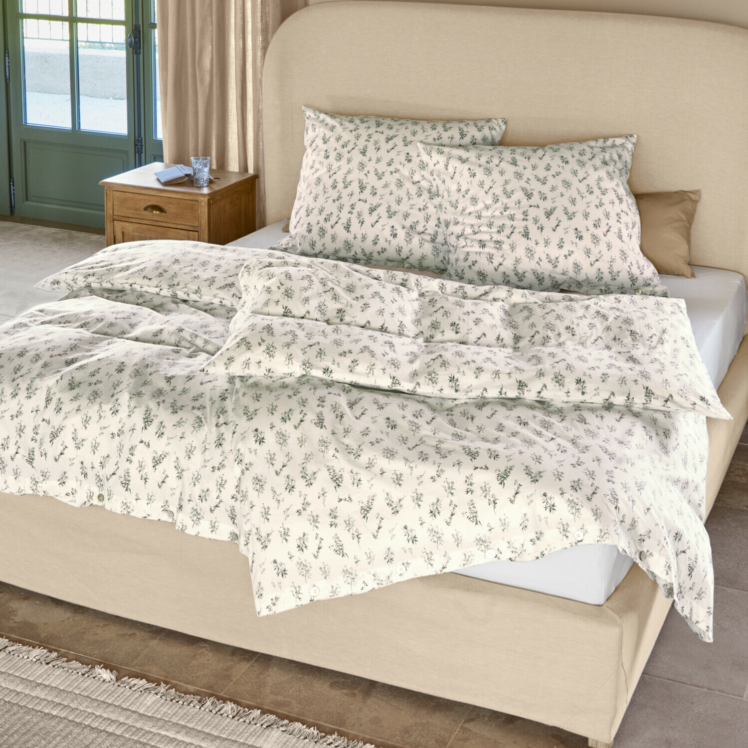 Beddengoed Somerlyn Katoenen beddengoed in crèmekleur met fijn groen plantenpatroon op bed met beige hoofdbord