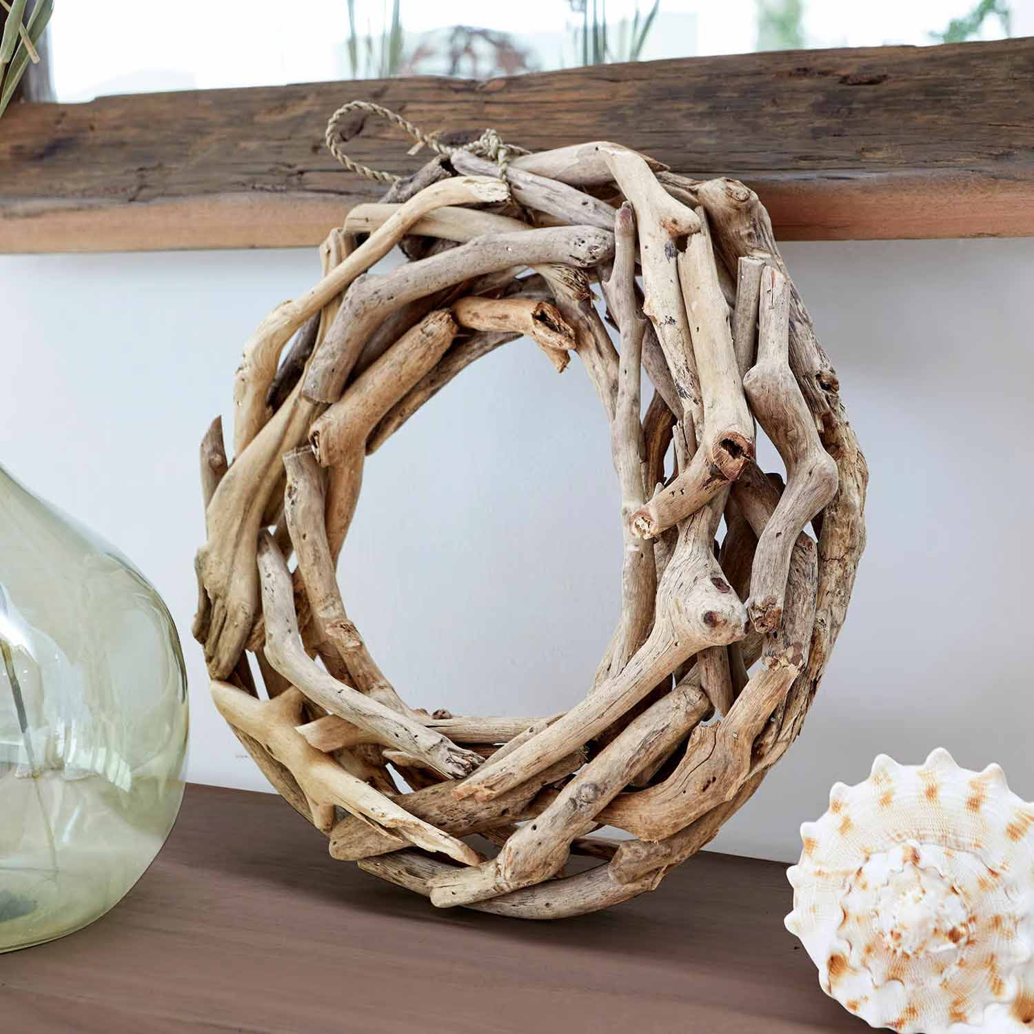 Ronde krans van natuurlijk drijfhout op een decoratieve tafel in een moderne woonkamer
