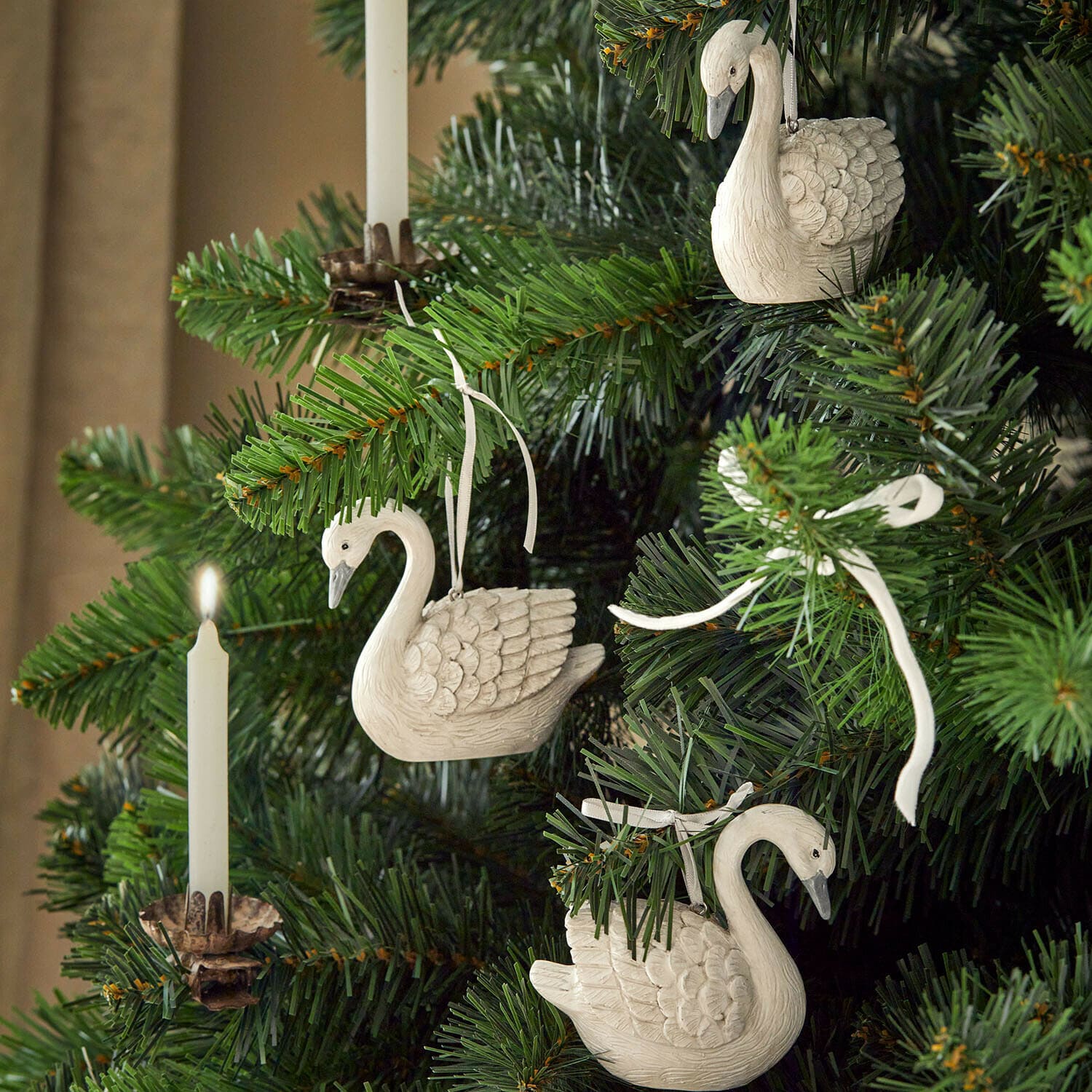 Hanger set van 3 Elarin Witte houten zwaanornamenten aan groene kerstboom met brandende witte kaars