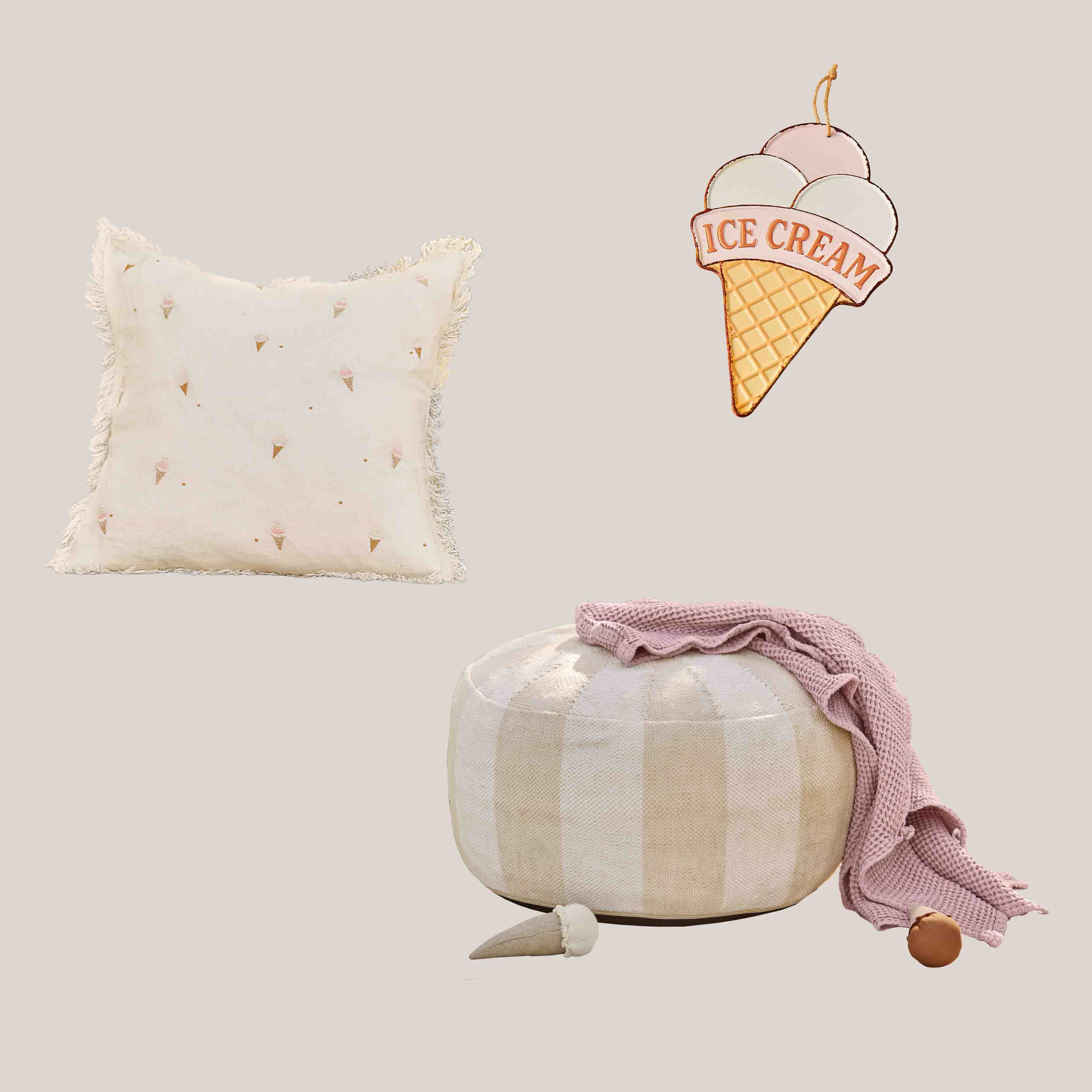 Beige kussen met franjes en ijsjespatroon, ronde geruite poef met roze deken