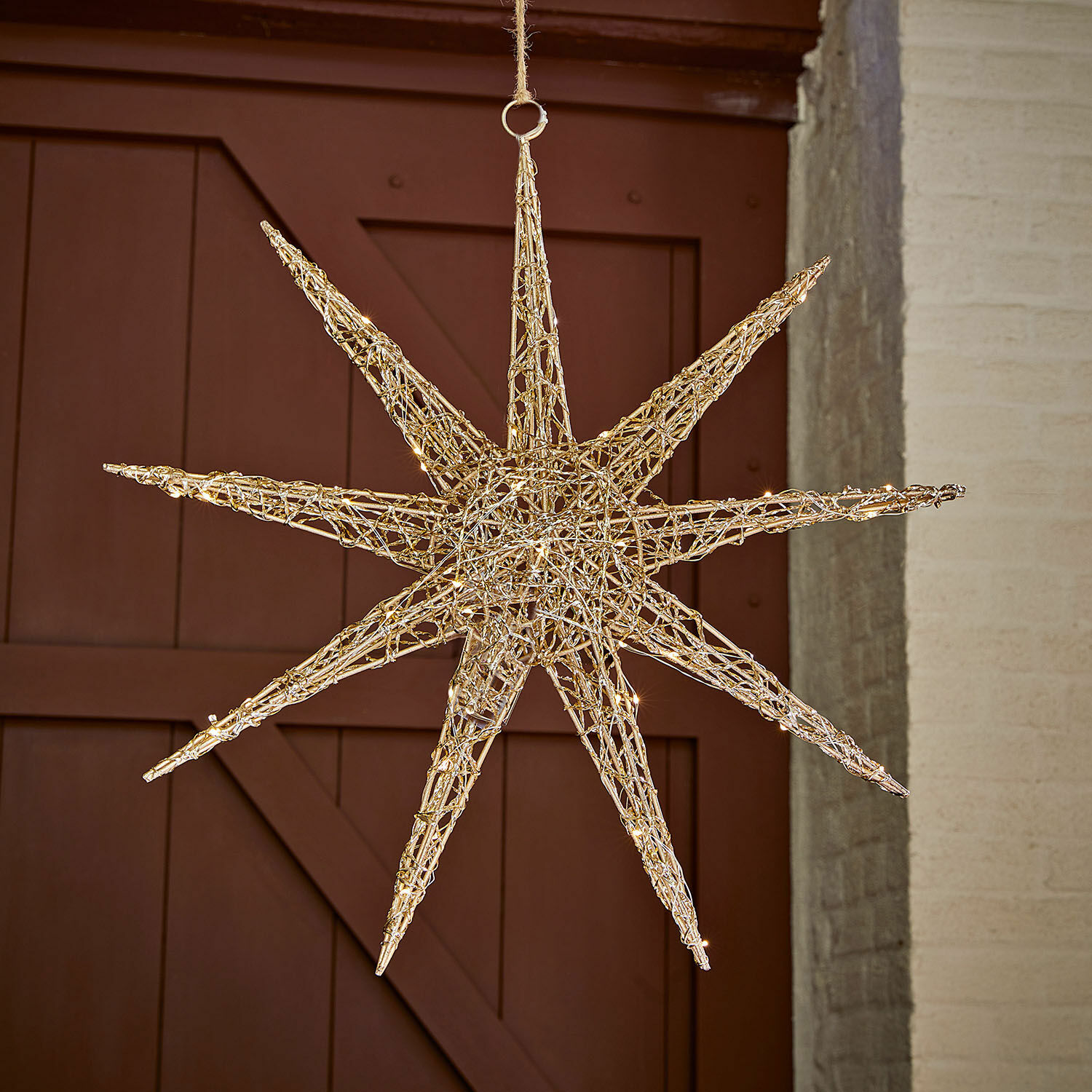 Decoratieve ster van natuurlijk wilgentenen met verlichting, feestelijke hangdecoratie