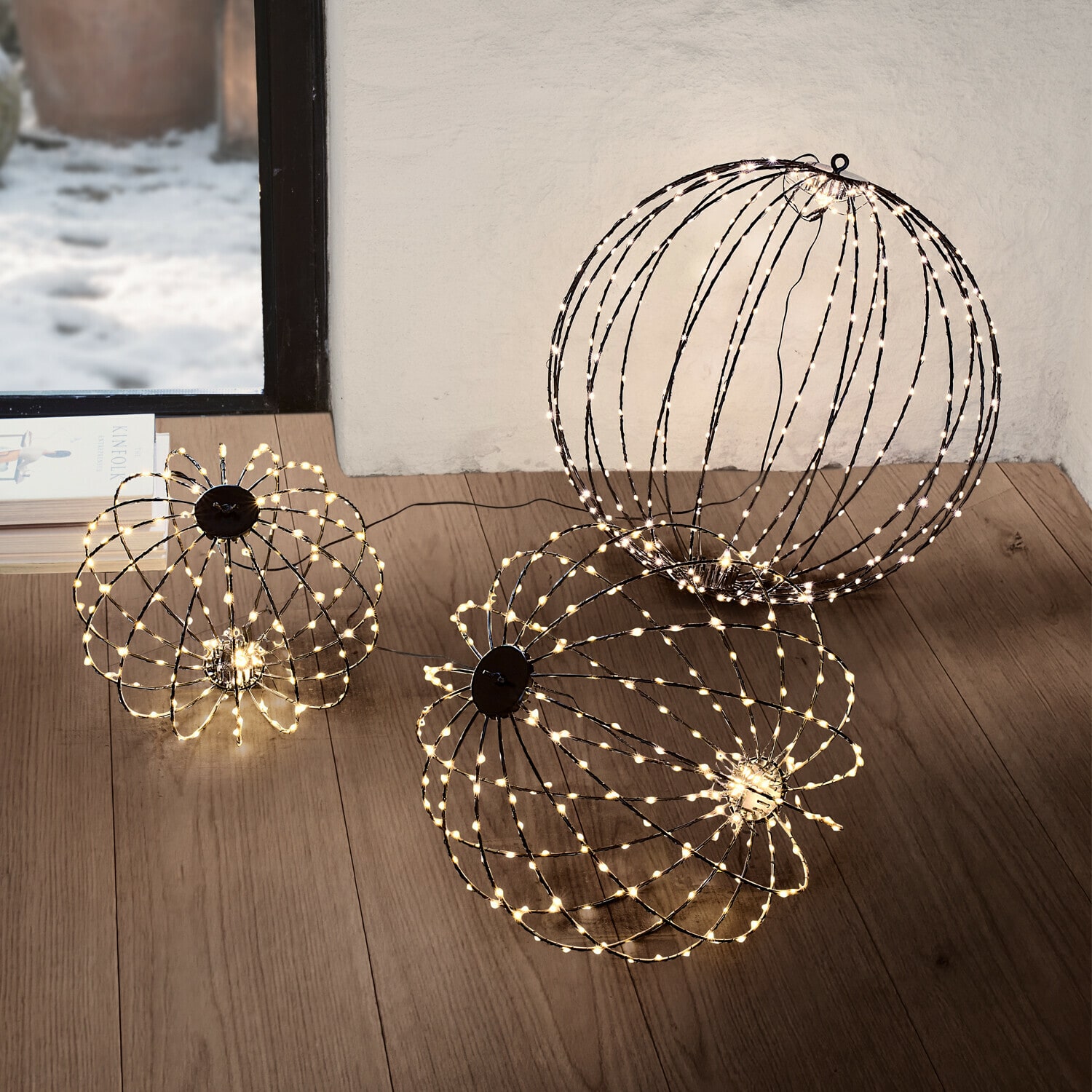 Ledlichtbol set van 3 Brilliante Twee decoratieve LED-lichtbollen in warm wit op de vloer van een moderne woonkamer