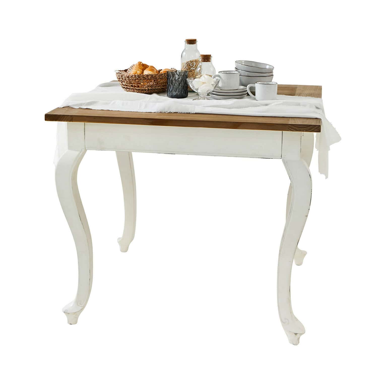 Tafel Plaish Houten tafel met witte poten en bruin blad, gedecoreerd met servies en broodmand