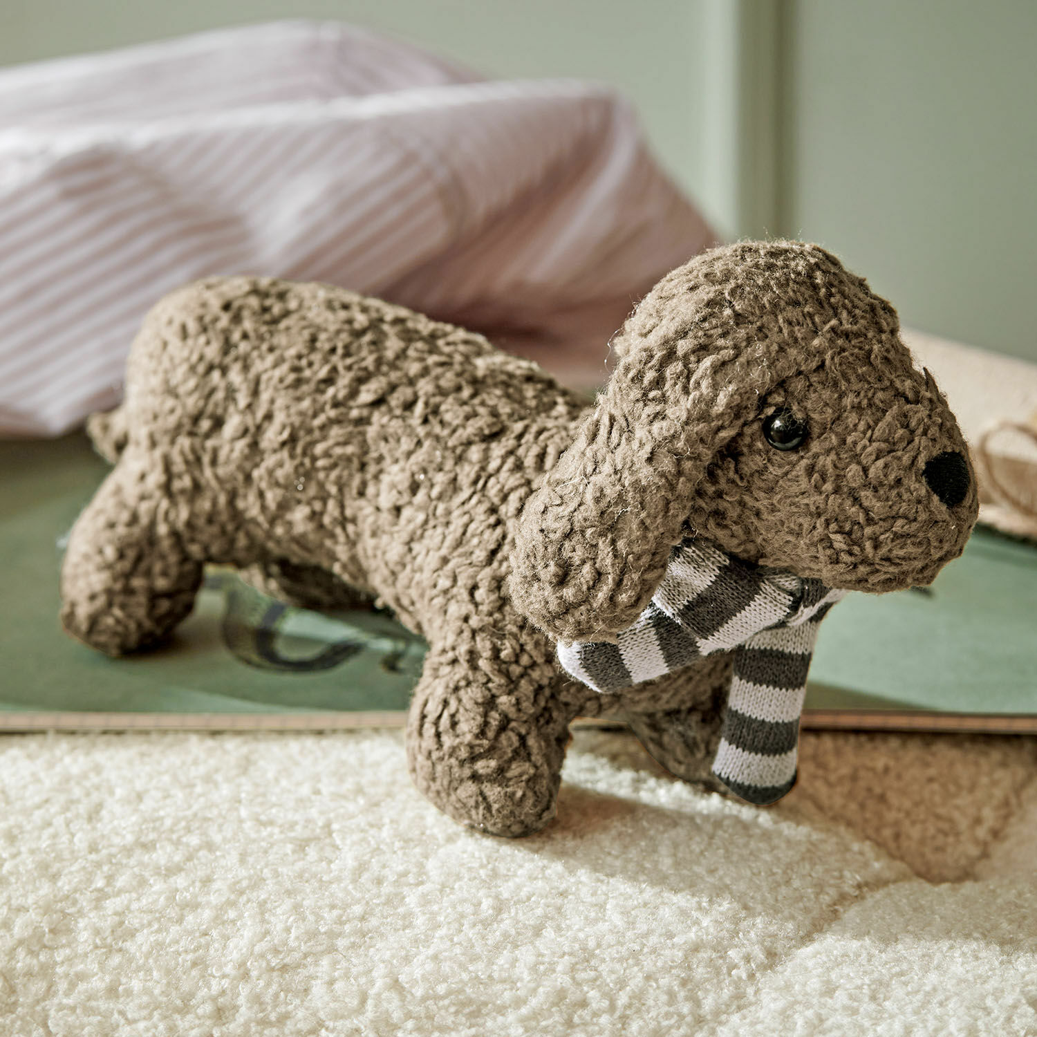 Knuffeldier met rammelaar Frolicks Bruine pluchen hond van zacht materiaal met grijs-witte gestreepte sjaal, kinderkamerdecoratie