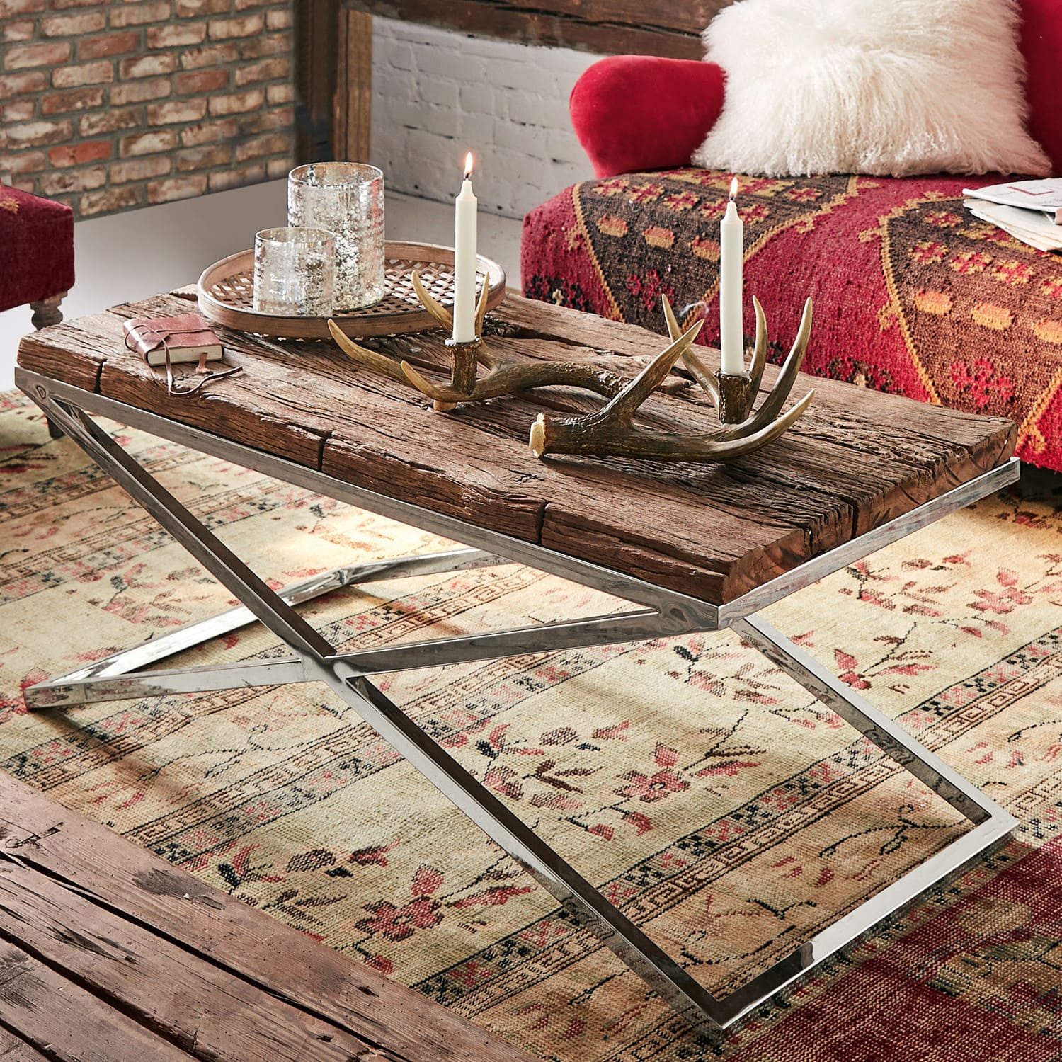 Rustieke salontafel van hout en metaal met kaarsen en gewei decoratie in woonkamer