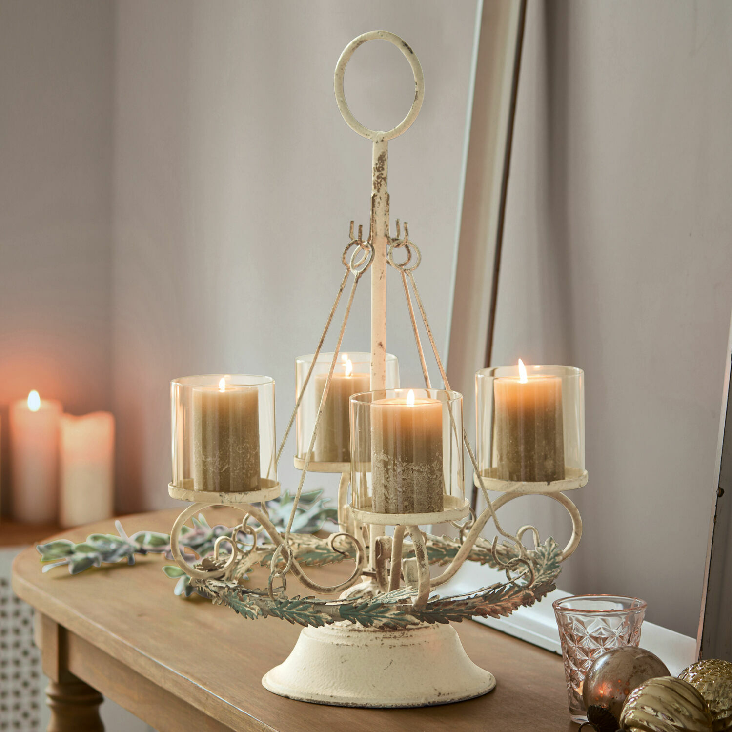 Adventskransstandaard Denders Vintage metalen kandelaar in crèmekleur met vier beige kaarsen op houten tafel, woondecoratie